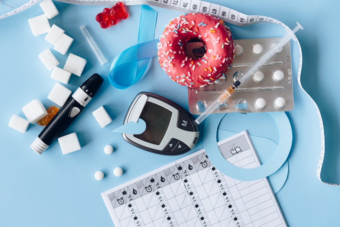 a donut and pills and a measuring tape